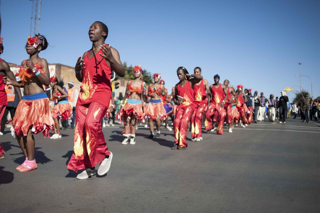 Participants dance in the road as the commemoration march makes its way to the Sowetan suburb of Orlando. (Ihsaan Haffejee)