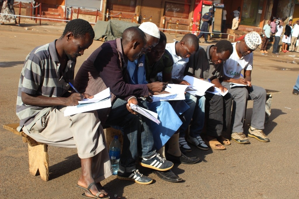  Political party polling agents at People's Plaza in downtown Kampala struggling to find voter's names on the register.