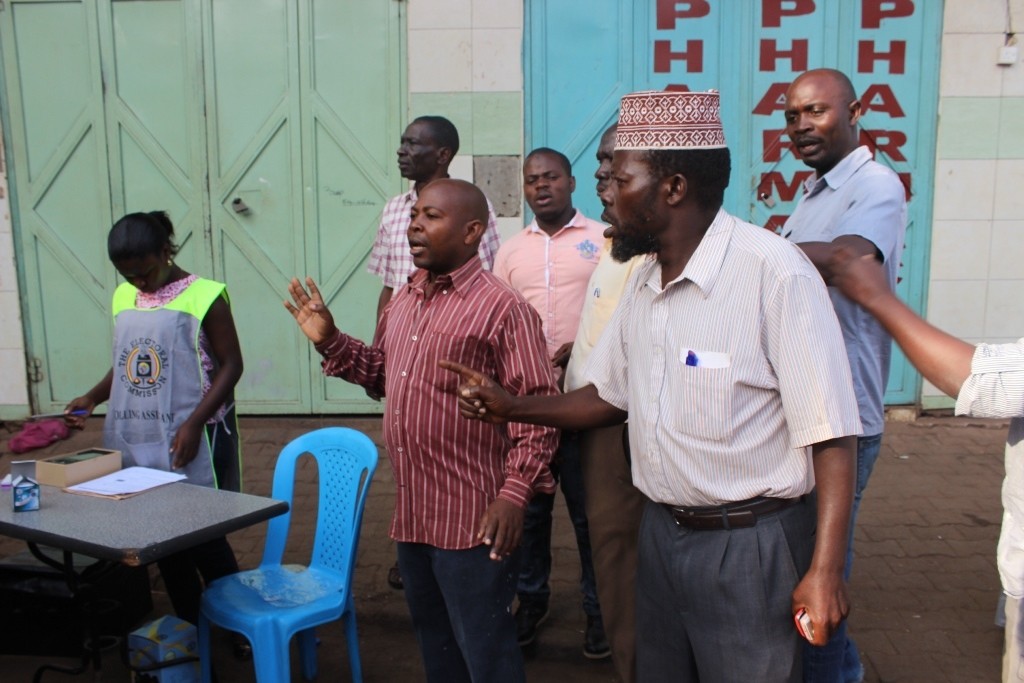 Angry voters at Superior Complex argue with officials and police over the later delay of voting materials.