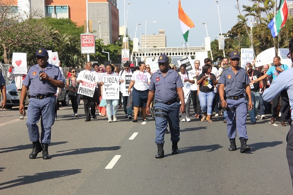 Police monitor activists marching to the Indian consulate in Durban