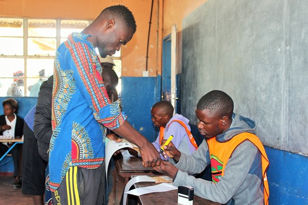 Inked and counted: A young man at Chawama Primary School has his thumb marked to indicate he has voted, but the new marking method raised concern among many voters forcing the Electoral Commission of Zambia to reassure the public the procedure was above board