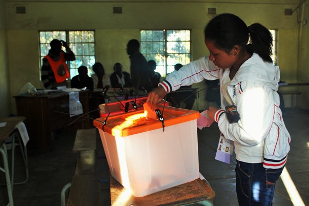 An early morning voter places her choice for president in the ballot box at Vera Chiluba Secondary School in Mtendere, eastern Lusaka where spiking pre-poll tensions caused concern over the peacefulness of the vote.