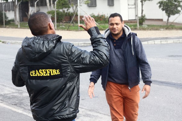 Devon greets a Ceasefire caseworker. Both work together against gangsterism and drug abuse in Hanover Park. Devon calls Shakur a â€œpoet for the people.â€